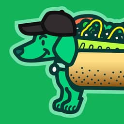 South Side Dog | Nick Volkert A smiling green dog wears a Chicago Dog costume while wearing a black baseball cap.